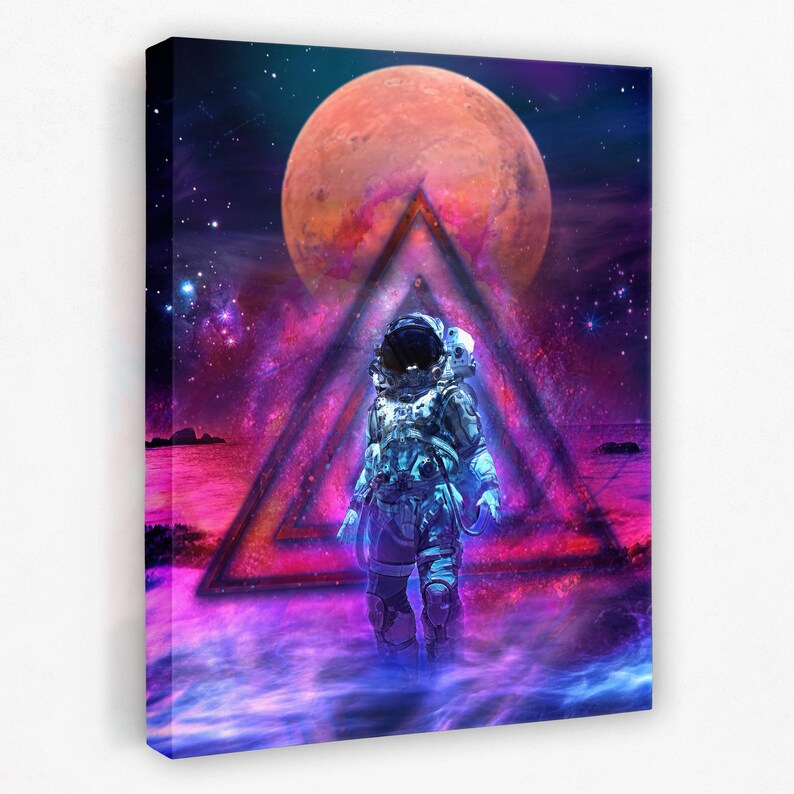 May include: An astronaut in a blue and white spacesuit stands in front of a glowing pink and purple triangle. The triangle is in front of a large, red planet in a dark blue sky with stars.