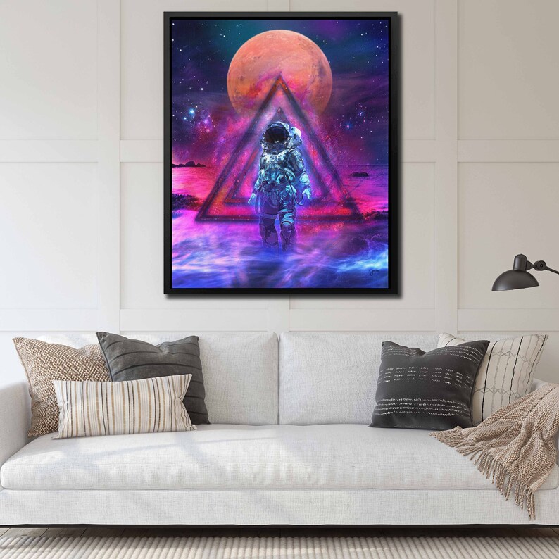 May include: An astronaut in a white spacesuit stands in a triangle of light, surrounded by a swirling nebula and a large red planet. The background is a dark blue space with stars.