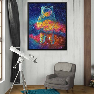 May include: A colorful abstract painting of an astronaut standing in front of a galaxy. The astronaut is wearing a white spacesuit and a helmet. The galaxy is a swirling mix of blues, purples, pinks, and oranges.
