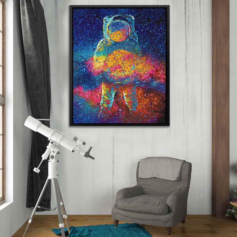 May include: A colorful abstract painting of an astronaut standing in front of a galaxy. The astronaut is wearing a white spacesuit and a helmet. The galaxy is a swirling mix of blues, purples, pinks, and oranges.