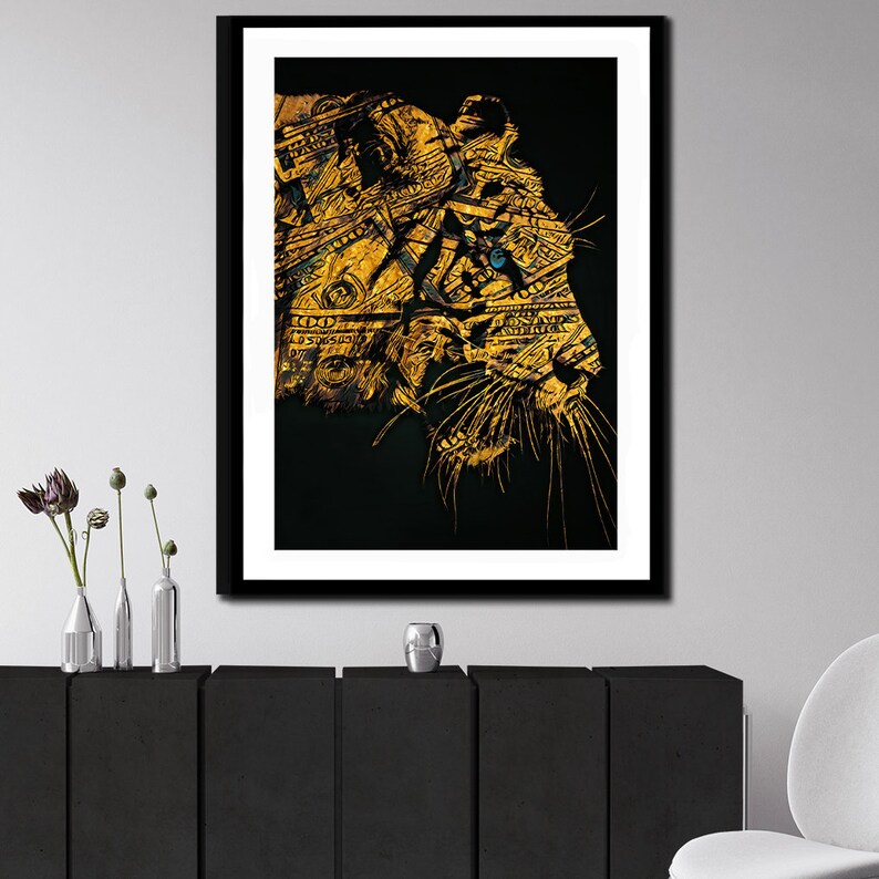 May include: An abstract art print of a tiger's face in gold and black, with dollar bills forming the tiger's fur. The background is black.