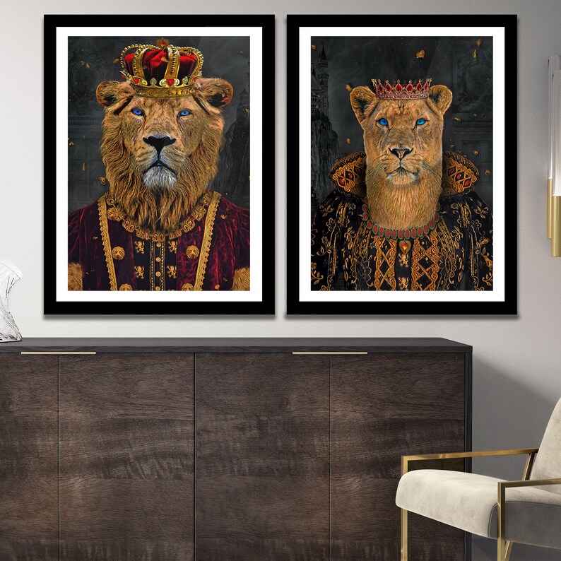 May include: Two framed portraits of a lion and lioness wearing crowns and royal robes. The lion is wearing a red robe with gold trim and the lioness is wearing a black robe with gold trim. Both portraits have a dark background.
