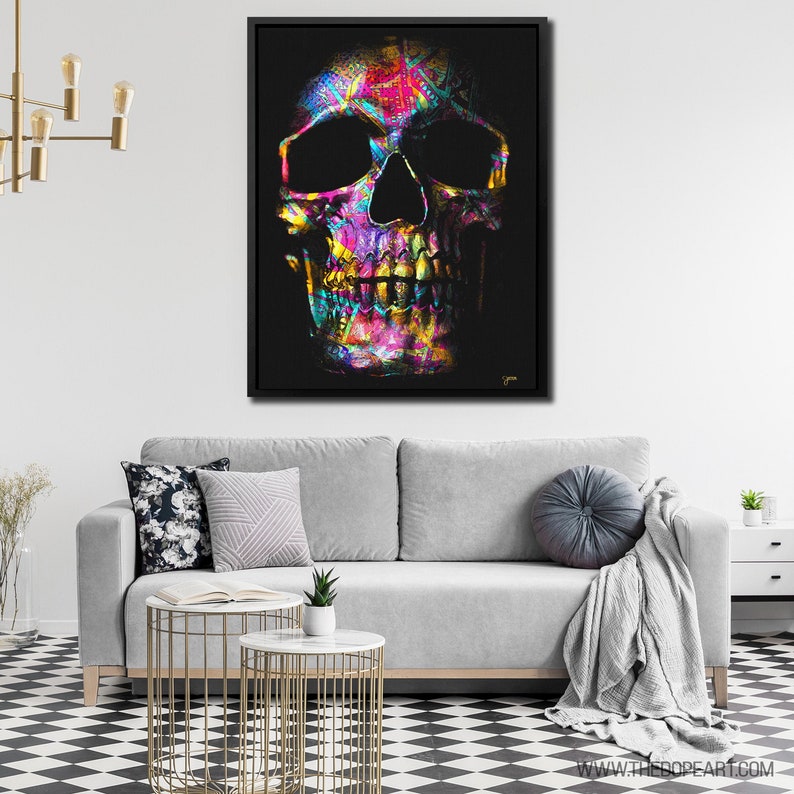 May include: A colorful skull with a black background. The skull is made up of a variety of colors, including pink, purple, blue, green, and yellow. The skull is a digital illustration.