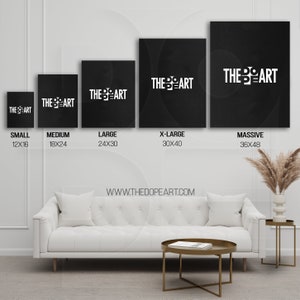 May include: Five black canvas prints with the text "THE ART" in white, displayed on a white wall above a white couch and a gold coffee table. The prints are labeled with sizes: Small (12x16 inches), Medium (18x24 inches), Large (24x30 inches), X-Large (30x40 inches), and Massive (36x48 inches). The text "WWW.THEDOPEART.COM" is displayed below the prints.