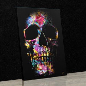 May include: A colorful skull with a black background. The skull is made up of a variety of colors, including pink, blue, green, yellow, and purple. The skull is a digital illustration.