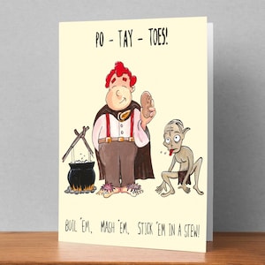 May include: A humorous greeting card featuring a cartoon illustration of a man with red hair holding a potato and a small, green, goblin-like creature. The text on the card reads "PO - TAY - TOES!" and "BOIL 'EM, MASH 'EM, STICK 'EM IN A STEW!"