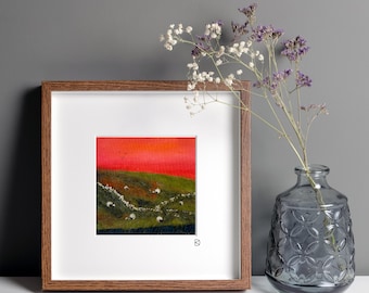 Original mixed media textile art, grazing sheep in a northern English landscape beneath a deep red sunset sky.