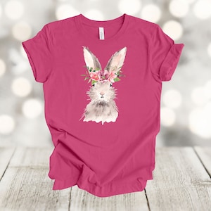 May include: Pink t-shirt with a watercolor illustration of a bunny wearing a floral crown.
