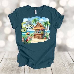 May include: Teal blue t-shirt with a graphic of a tropical beach scene with a tiki hut, palm trees, a parrot, and the text "It's 5 o'clock here!"