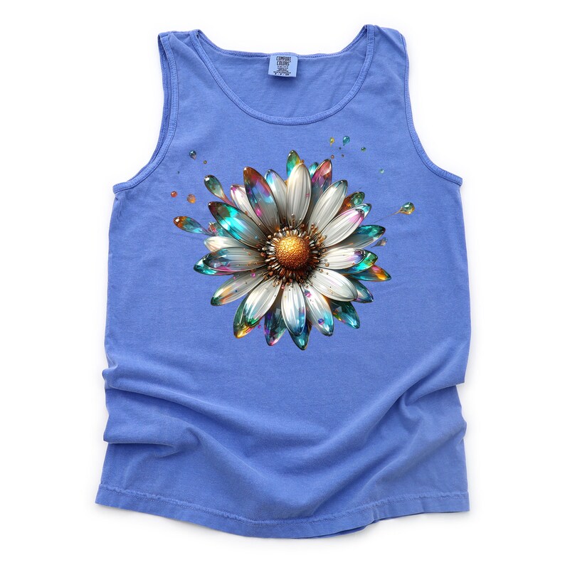 May include: A blue tank top with a colorful, iridescent daisy graphic. The daisy has a white center and petals with a rainbow sheen.