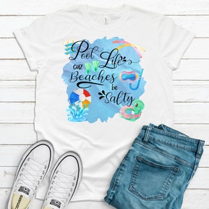 May include: White t-shirt with a blue watercolor background and the text "Pool Life cuz Beaches be Salty". The design includes various summer-themed icons like a diving board, flippers, a beach ball, a snorkel, and a pool float.