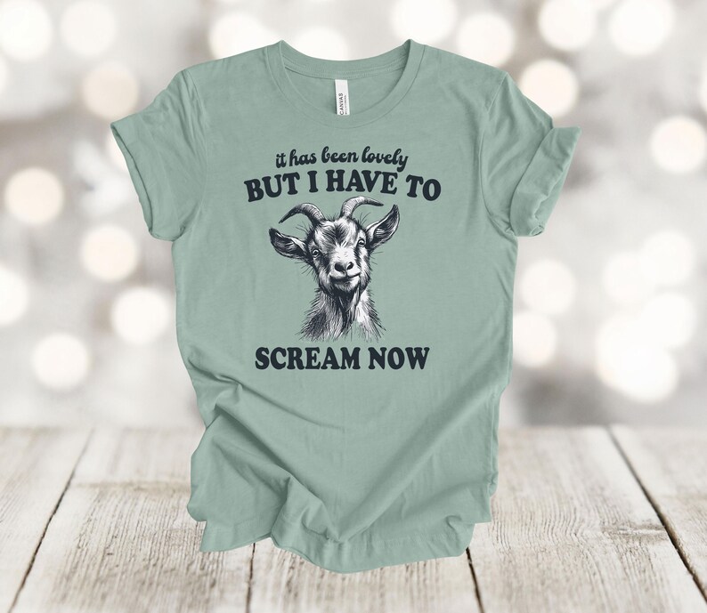 May include: A light green t-shirt with a black goat illustration and the text "it has been lovely BUT I HAVE TO SCREAM NOW".
