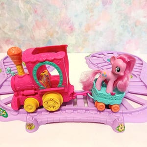 May include: A set of three ceramic mugs with a speckled, matte finish. Each mug features a different color: light blue, cream, and gray. The mugs have a simple, modern design and a comfortable handle.