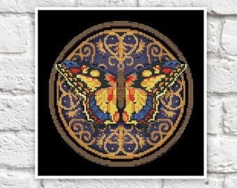 May include: A circular design with a gold frame and intricate blue and gold patterns. A colorful butterfly with yellow, orange, red, and blue wings is centered in the design.