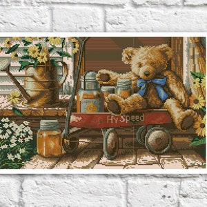 May include: A brown teddy bear wearing a blue bow tie sits in a red wagon with jars of honey and a watering can. The wagon has the words "Hy Speed" printed on the side. The scene is set in front of a brick wall with sunflowers and daisies.