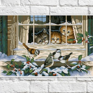 May include: A cross-stitch pattern featuring four kittens looking out a window with three birds perched on a snowy ledge. The kittens are brown and white, and the birds are brown, white, and gray.