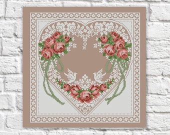May include: A cross-stitch pattern featuring a heart-shaped design with a white lace border and pink roses. The heart is filled with a delicate floral pattern and two doves.