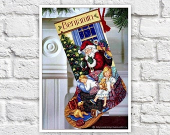 May include: A Christmas stocking with a personalized name "Benjamin" embroidered on the top. The stocking features a colorful illustration of Santa Claus, children sleeping, and a Christmas tree.