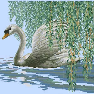 May include: A white swan with a long neck and black eyes swims in a blue body of water. The swan is partially hidden under a weeping willow tree with green leaves.