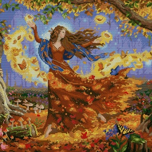 Puede incluir: Una mujer con el pelo largo y castaño baila en un bosque, rodeada de hojas de otoño que giran. Lleva un vestido azul y marrón con una falda fluida. Las hojas son de tonos amarillos, naranjas y rojos, y el fondo es un desenfoque de azul y morado.