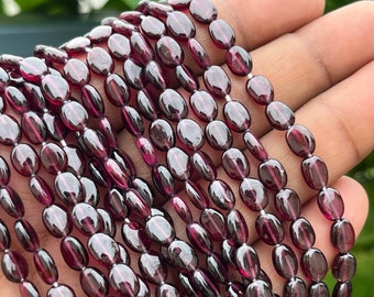 AAA Rhodolite Garnet Gemstone Beads: Smooth Oval Shape, 16 Inch Strand
