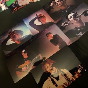 May include: A collage of images featuring various musicians. The images are in black and white and color, and show the musicians performing on stage and in studio settings. Some of the musicians are wearing sunglasses, hats, and other accessories. The images are arranged in a grid pattern.