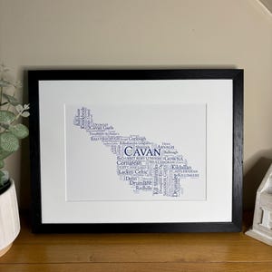 Cavan GAA Irish Themed Word Art Poster Print by Ireland With Love Printed in sizes A5 A4 and A3 offered as print only, framed or matted with all the Cavan GAA clubs listed in the Cavan colours in the shape of county Cavan this print can also be personalised