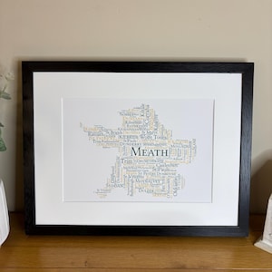 Meath GAA Clubs Irish Themed Word Art Poster Print by Ireland With Love Printed in sizes A5 A4 and A3 offered as print only, framed or matted with all the county GAA clubs listed in the county colours in the shape of the county, this print can also be personalised