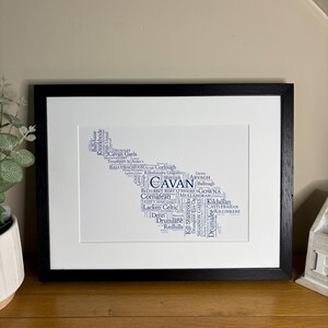 Cavan GAA Irish Themed Word Art Poster Print by Ireland With Love Printed in sizes A5 A4 and A3 offered as print only, framed or matted with all the Cavan GAA clubs listed in the Cavan colours in the shape of county Cavan this print can also be personalised