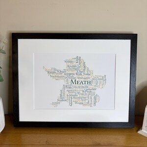 Meath GAA Clubs Irish Themed Word Art Poster Print by Ireland With Love Printed in sizes A5 A4 and A3 offered as print only, framed or matted with all the county GAA clubs listed in the county colours in the shape of the county, this print can also be personalised