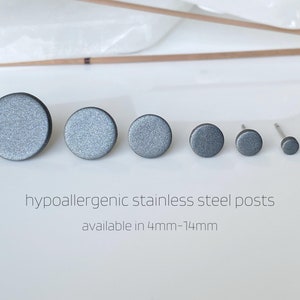 May include: Six different sizes of round, dark grey stud earrings with hypoallergenic stainless steel posts. Available in sizes from 4mm to 14mm.