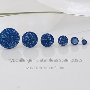 May include: A set of six blue glitter stud earrings with hypoallergenic stainless steel posts. The earrings are available in sizes from 4mm to 14mm.