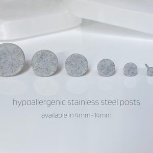 May include: Six different sizes of round, white, speckled earrings with hypoallergenic stainless steel posts. Available in sizes 4mm-14mm.