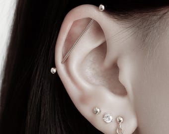 Industrial piercing in verschillende kleuren met steentjes