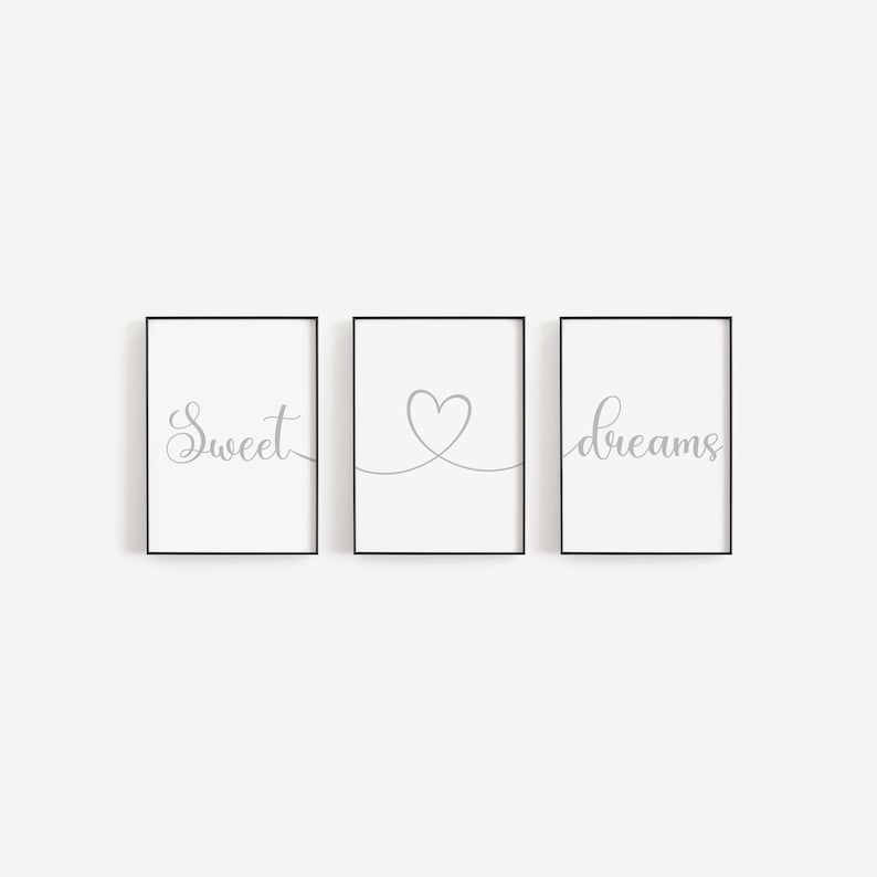 May include: Three black framed prints with white backgrounds. The left print has the word "sweet" in gray cursive script. The middle print has a gray heart drawn with a continuous line. The right print has the word "dreams" in gray cursive script.