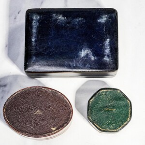 May include: A rectangular dark blue box with a worn finish, a brown oval box with a textured surface, and a small green octagonal box. The brown box features the text "MADE IN ITALY" and the green box also features the text "MADE IN ITALY".