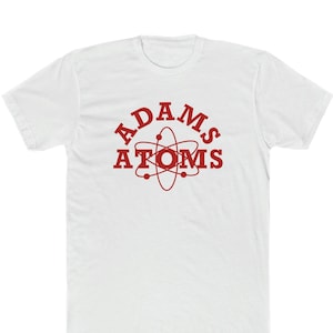 May include: White t-shirt with a red graphic of an atom with the text "ADAMS ATOMS" around it.