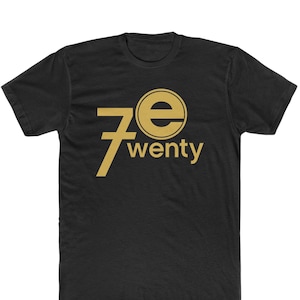 May include: Black t-shirt with a gold graphic of the number 7 and the letter "e" in a circle, with the word "wenty" below it.
