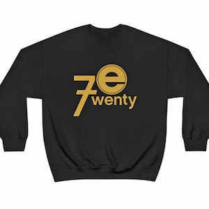 May include: Black sweatshirt with a gold graphic of the number 7 and the letter "e" in a circle, with the word "twenty" below it.