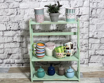 Shabby wooden kitchen shelf spice rack in shabby vintage country house style sage green