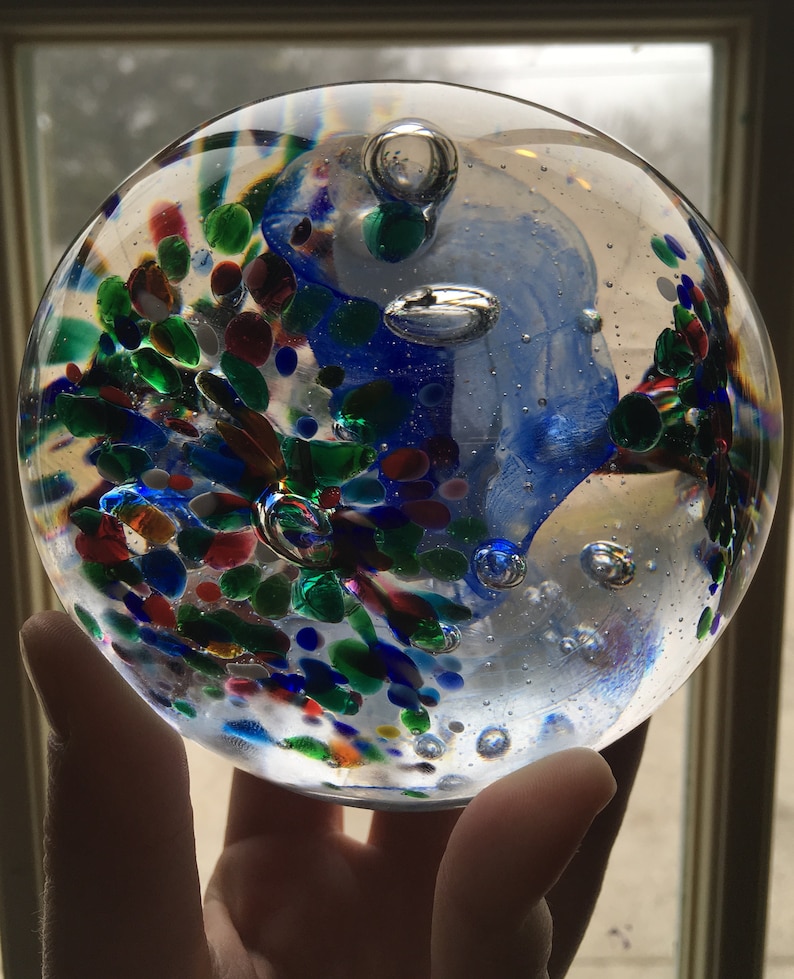 Blue and Red Mix BlueWhite center with Green Blown Glass Large Tri-Flower Paperweight on a Dark Wooden Light Box