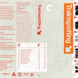 May include: A DVD cover for the film Trainspotting, featuring a bright orange arrow pointing down with the title "Trainspotting" in white text. The cover also includes a series of black and white photos of the actors from the film.