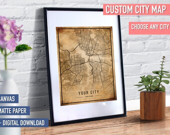 May include: Framed custom city map print with a vintage aesthetic. The map is in a black frame with a white mat. The text "CUSTOM CITY MAP" and "CHOOSE ANY CITY" are displayed at the top. The text "YOUR CITY" is at the bottom.