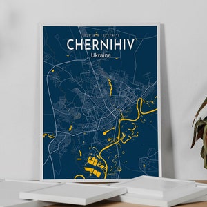 May include: A blue and yellow city map print of Chernihiv, Ukraine. The map is framed and hanging on a white wall.