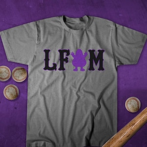 May include: A gray t-shirt with a purple character and the text "LFM" in black.