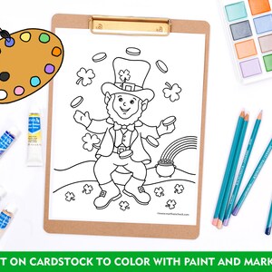 May include: A black and white coloring page featuring a leprechaun juggling gold coins. The leprechaun is wearing a hat with a shamrock on top and a green vest. He is standing on a hill with a rainbow and a pot of gold at the end. The page is surrounded by paintbrushes, paint, and markers.