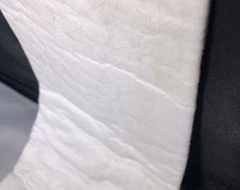 May include: A white, textured, rectangular piece of insulation material.