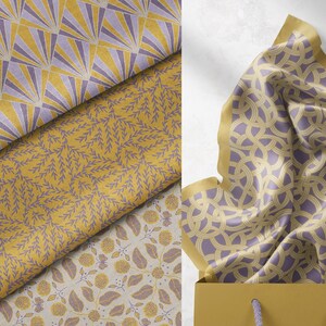 May include: A set of four fabric swatches with different geometric and floral patterns in shades of yellow and purple. The fabrics are folded and arranged on a white background.