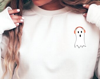 May include: White sweatshirt with a ghost wearing headphones graphic on the front.