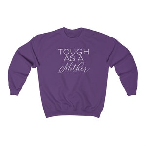 May include: Purple sweatshirt with the text "TOUGH AS A MOTHER" in white.